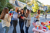 Teenagers talking in the street at a block party