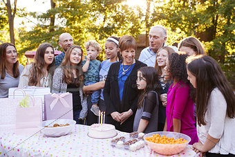 Friends and family gathered in a garden for a birthday party