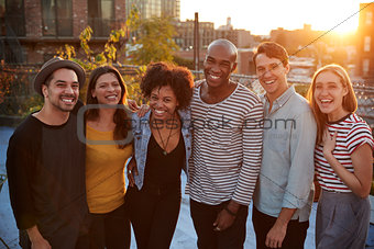 Group portrait of friends at a rooftop party in Brooklyn