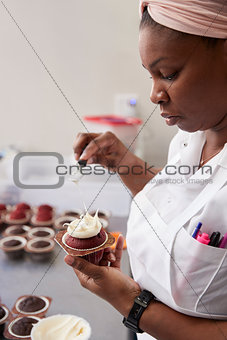 Young black woman preparing food in a bakery, close up