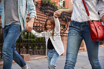 Family taking a walk down the street