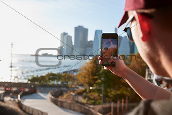 Young man taking a photo from a footbridge