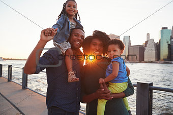 Young family with daughters standing on quayside