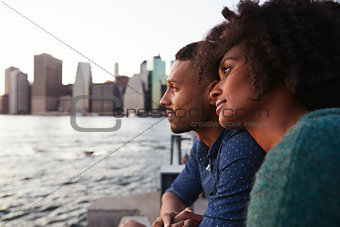 Young black couple standing on quayside, close up