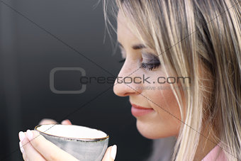 woman drinking coffee in the morning at restaurant soft focus on the eyes