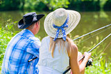 Couple, woman and man, with fishing rods sport angling