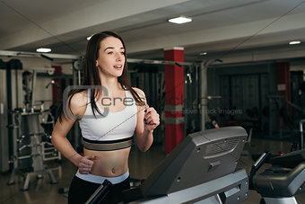 Young pretty girl is trained in the gym