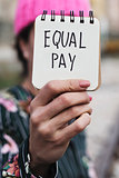 woman with a pink hat and the text equal pay 