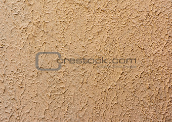 fragment of beige wall with decorative plaster of waves