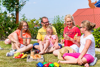 Family having picnic in garden front of their home