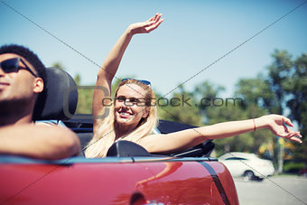 Young woman in cabriolet car departs for the summer holidays