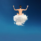 Young girl practices yoga over a cloud