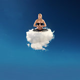 Pregnant woman doing yoga on a cloud