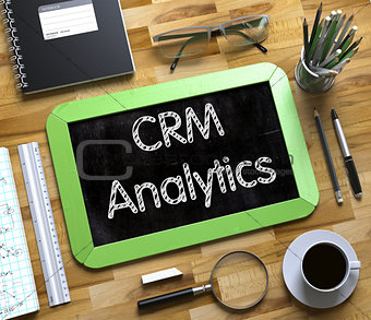 CRM Analytics Handwritten on Small Chalkboard.