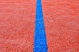 Blue line on red playing field. Copy space. Sport texture and background