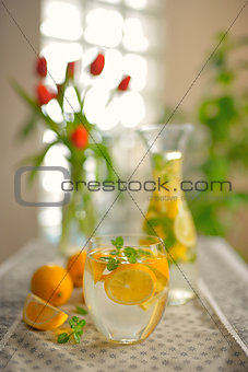Fresh limes and lemonade on table