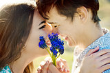Close up portrait of a loving couple. selective focus on flowers