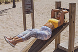 Woman in sportswear training in gym outside