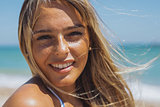Wonderful woman smiling in sunshine on beach