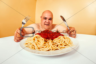 Hungry fat man eating spaghetti