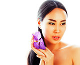 young pretty real asian woman with flower purple orchid close up