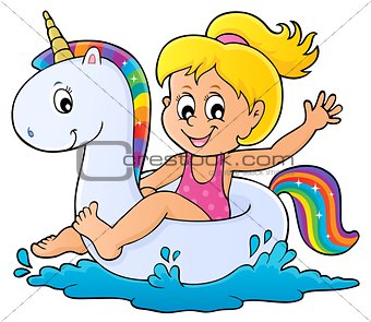 Girl floating on inflatable unicorn 1