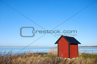 Red cabin by the sea