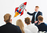 Businessman drawing a rocket during a training meeting. Concept of business improvement and enterprise startup