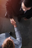 Handshaking business person in office. concept of teamwork and partnership
