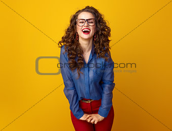 cheerful young woman on yellow background