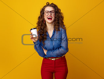 happy stylish woman on yellow background with coffee cup