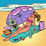 Beautiful woman in bikini sunbathing on the beach