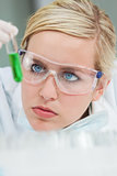 Female Scientist & Green Test Tube In Laboratory 