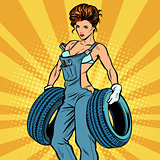 woman in overalls with tires, car service