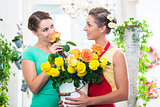 Women in flower store enjoying the roses