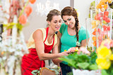 Florist woman and customer in flower shop