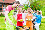 Family having barbeque at garden party