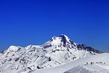 Off-piste slope and mount Kazbek at sun winter day