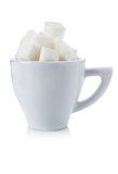 Cubes of white sugar in a white cup