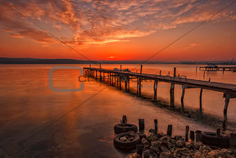 Stunning sunset at the harbour with wooden pier