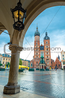 Vertical postcard view of the main square of Krakow. Mary's chur