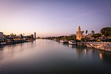 Blue Hour view of Golden tower or Torre del Oro, along the Guadalquivir river, Seville, Spain.