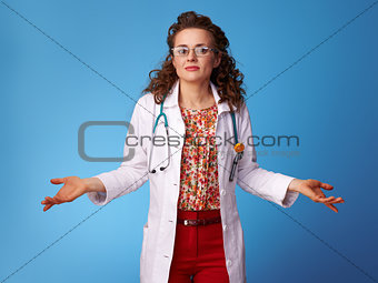 paediatrist doctor shrugging shoulders on blue