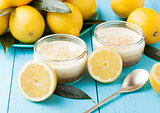 Glass jar with lemon cheesecake with fresh lemons