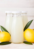Glass bottles of organic fresh lemon juice fruits