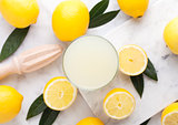 Glass of organic fresh lemon juice and fruits