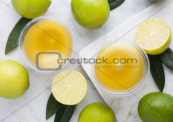 Plastic cups with lime and biscuit dessert 