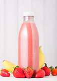 Plastic bottle with fresh summer berries smoothie