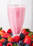 Milkshake glass with fresh summer berries smoothie