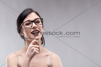 Young smiling woman against grey background